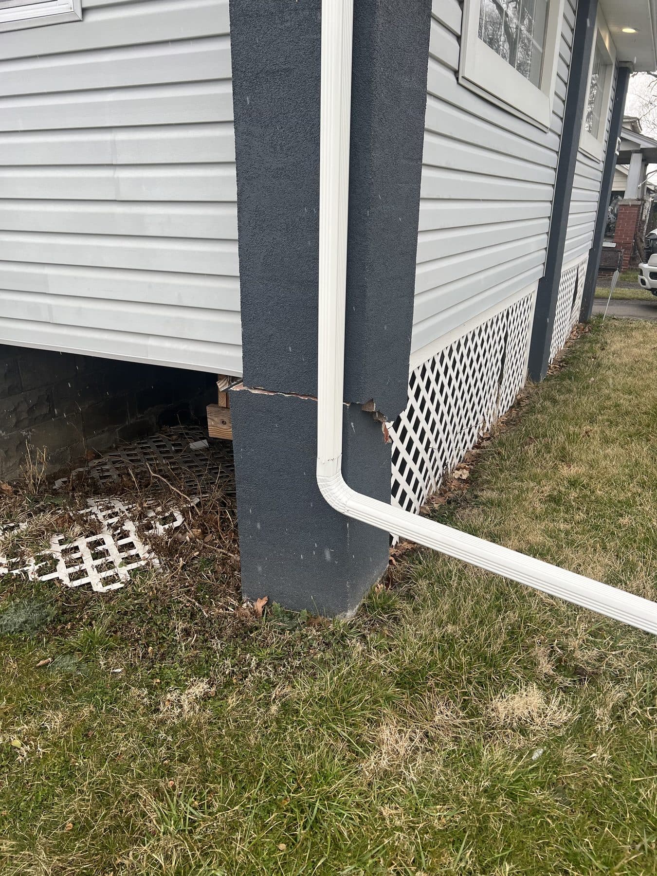 After: the same foundation corner rebuilt, parged smooth, and finished