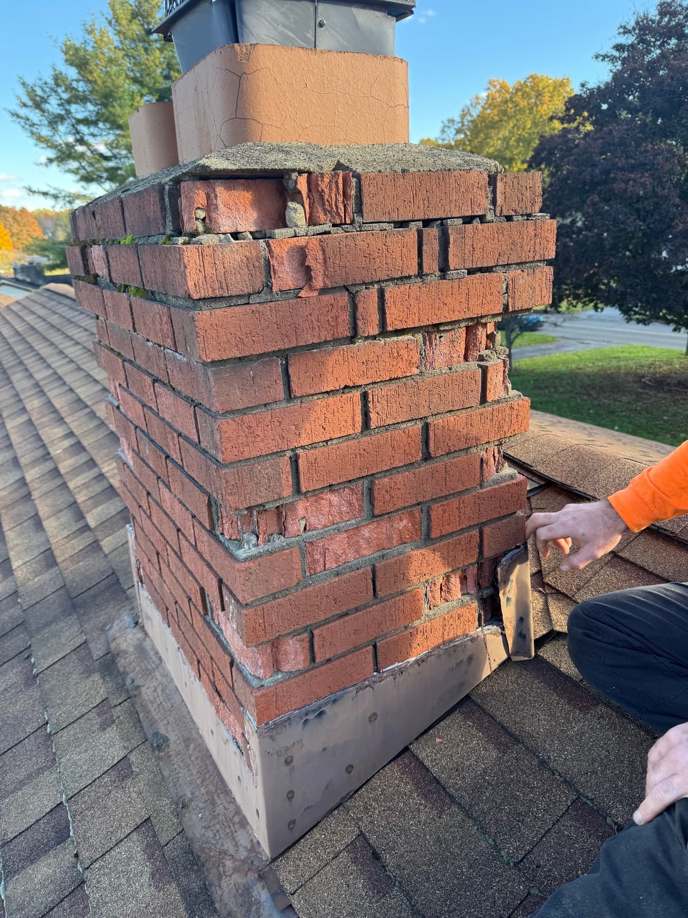 Before: a chimney with spalling brick faces and crumbling mortar joints
